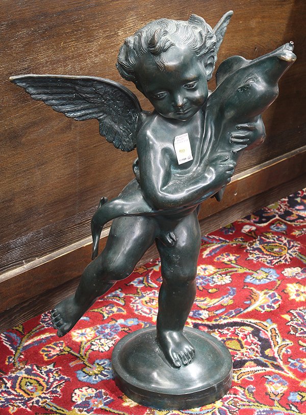 Patinated bronze figural fountain: Patinated bronze figural fountain, Continental school, the playful cherub depicted clutching a dolphin and rising on a circular plinth, 28''h x 18''w