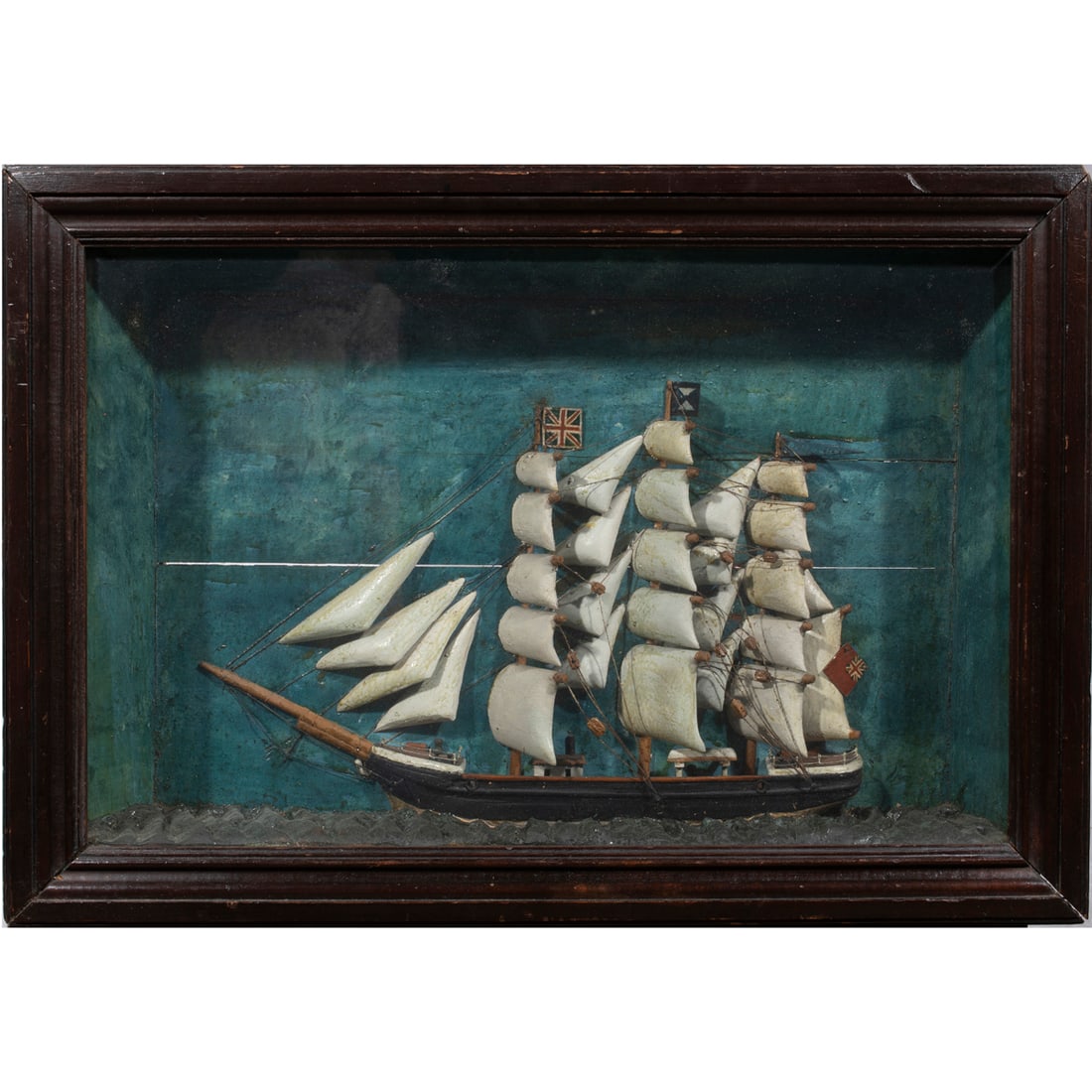 A shadow box ship diorama: A shadow box ship diorama, depicting a three-masted full rigged boat with overall 13.75"h x 20"w x 3.25"d