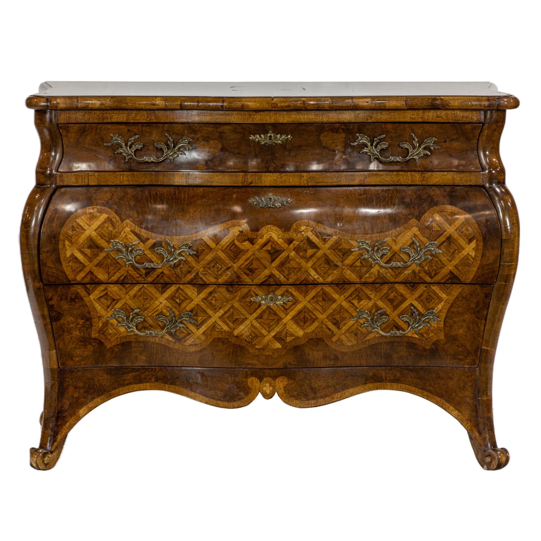 A Louis XV style inlaid burl walnut commode: A Louis XV style inlaid burl walnut commode, the crossbanded outset shape top over a bombe case consisting of three drawers, the drawer frieze inlaid with a lattice cartouche panel, rising on scroll f