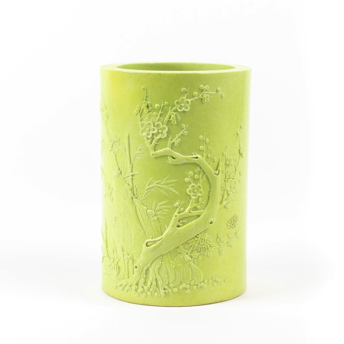 Chinese lime-green biscuit glazed brush pot: Chinese lime-green biscuit glazed brush pot. Decorated in raised relief with a grouping of prunus, bamboo, orchid and chrysanthemum, the recessed base featuring a four-character maker's mark, Republic
