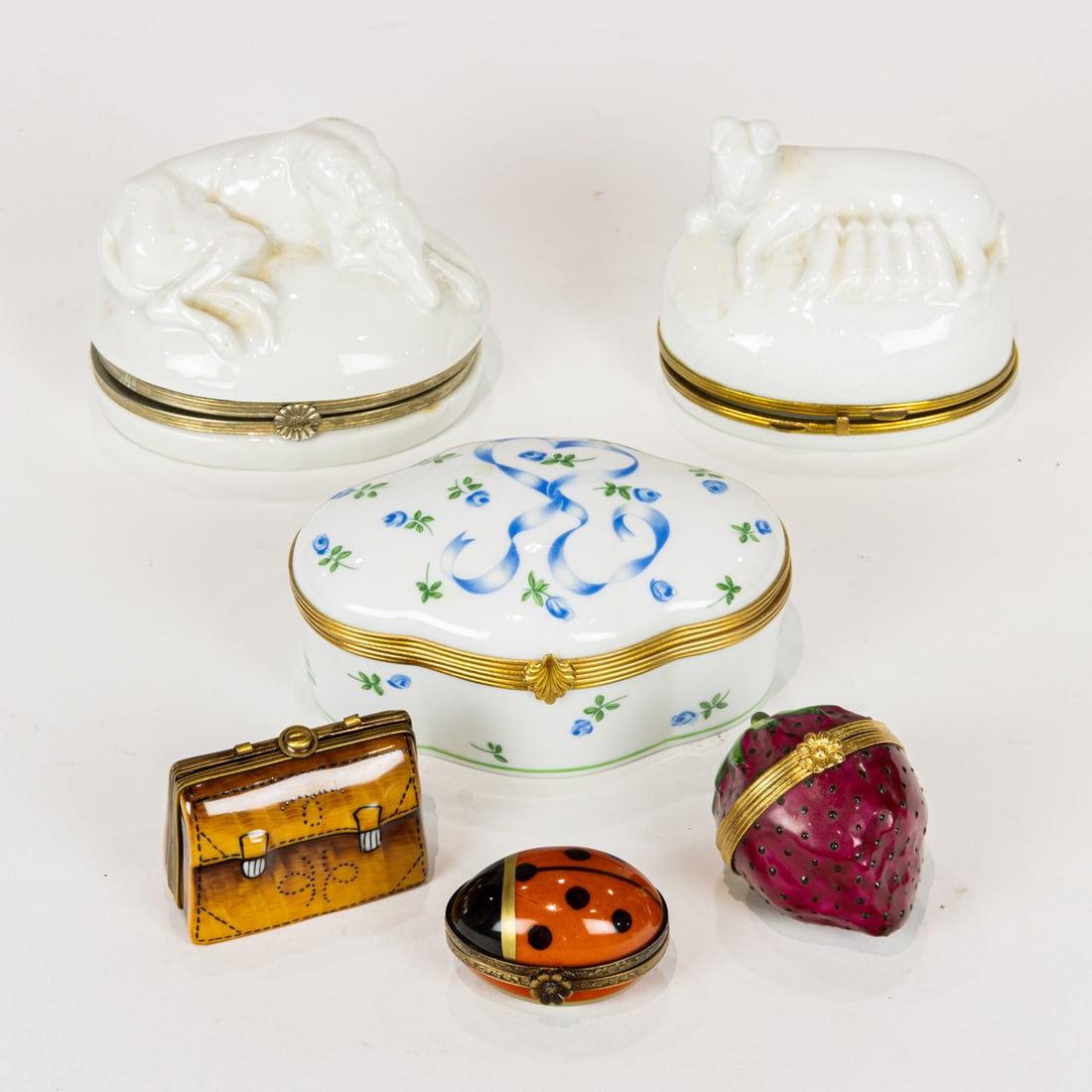A group of Limoges porcelain trinket boxes, including Raynad et Cie, Tiffany & Co.: A group of Limoges porcelain trinket boxes, including Raynad et Cie, Tiffany & Co. and Rochard, together with Continental box with recumbent greyhound, greatest 4"l