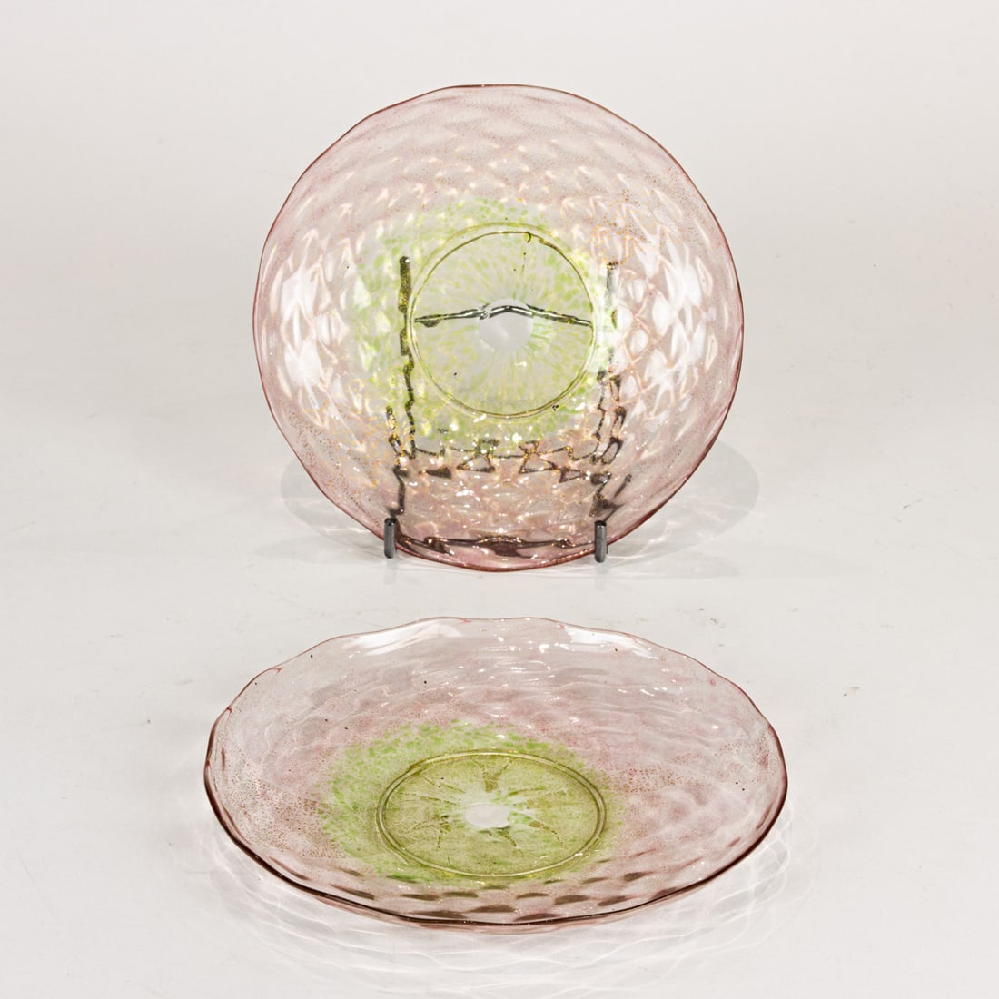 Two Murano gilt flecked glass plates: Two Murano gilt flecked glass plates, each shading from pink to green, 7.5"dia