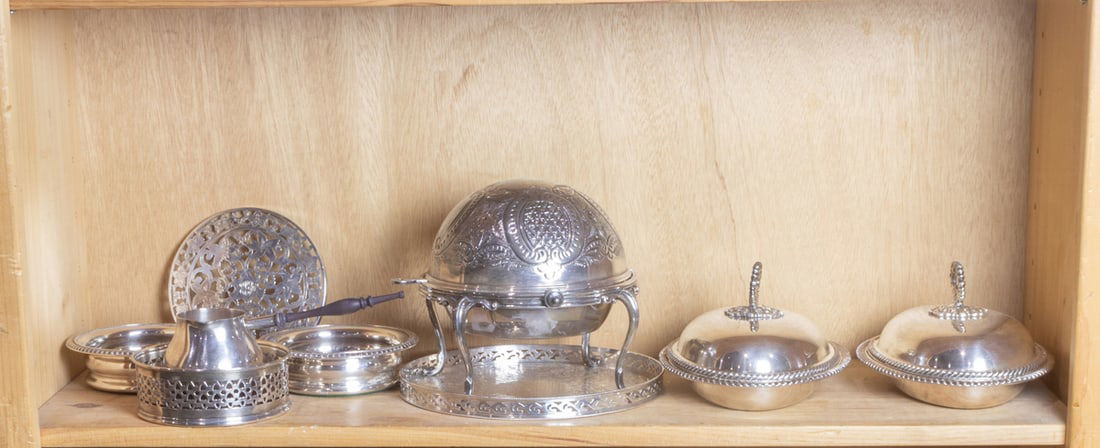 An assembeled group of silver plate: An assembeled group of silver plate, including (3) wine coasters; trivet; covered caviar dish with stand; pair of covered vegetable bowls and a brandy warmer