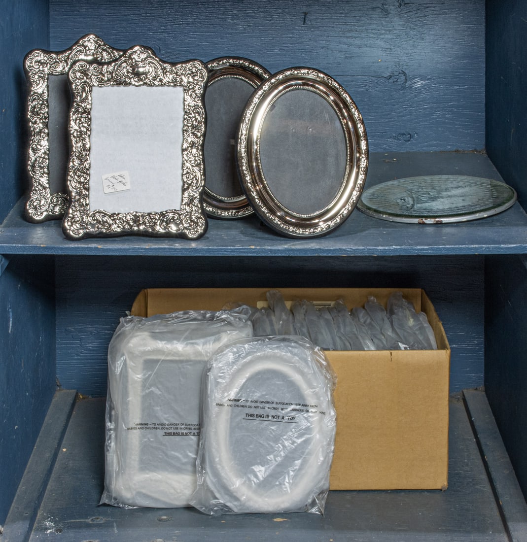 A collection of twenty-four silver plated oval and rectangular photograph frames: A collection of twenty-four silver plated oval and rectangular photograph frames, mainly fits rectangular photos meausring 7.5"h x 5"w and oval images 7"h; together with a cut glass mirrored dressing