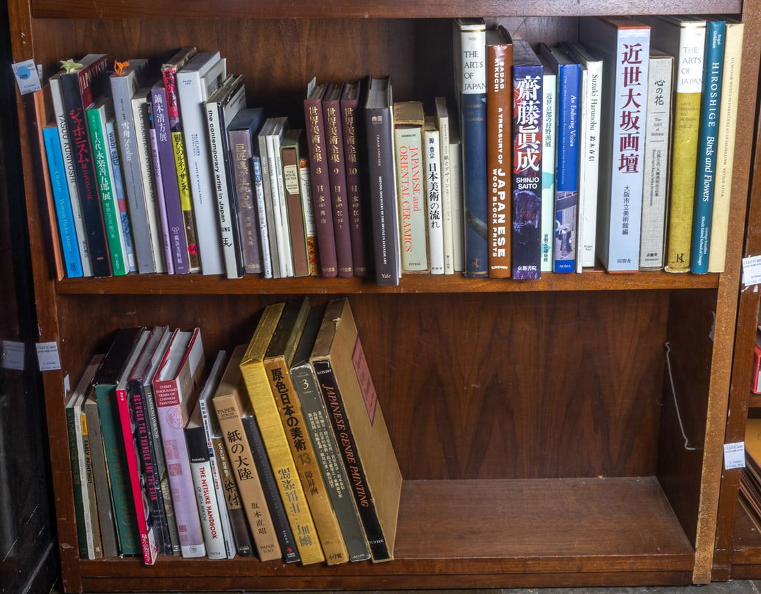 Two shelves of books mainly relating to Japanese art: Two shelves of books mainly relating to Japanese art, including 'Shinjo Saito', 'Sizuki Harunobu'; 'Shinto: Discovery of the Divine in Japanese Art'; 'Waist Down: Skirts by Muccia Prada'; 'Yasuo Kuniy