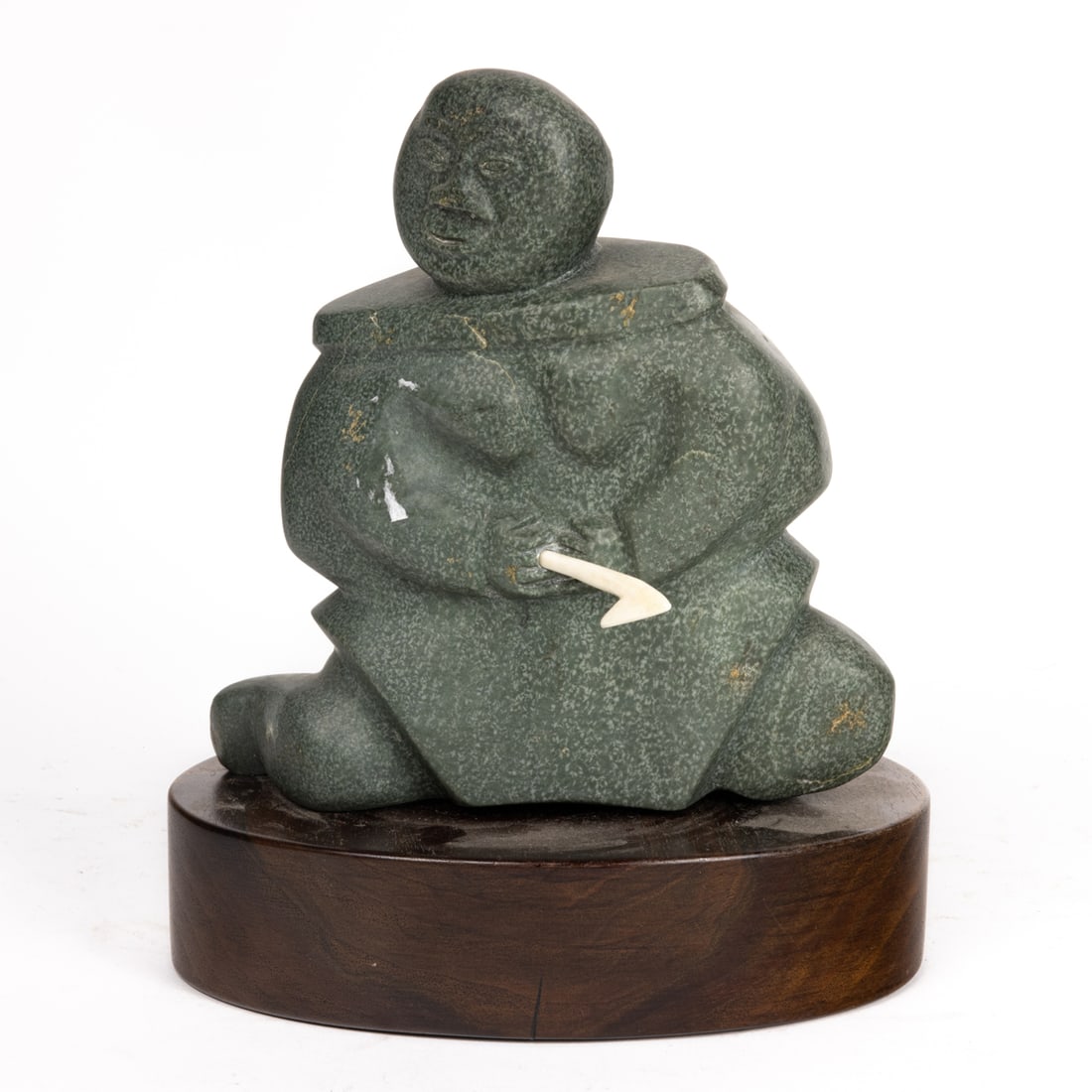 An Inuit sculpture of a fisherman, 7"h x 7"w: An Inuit sculpture of a fisherman, 7"h x 7"w.