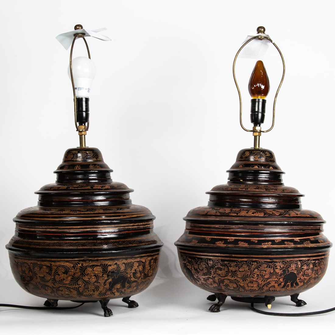 A pair of Burmese incised black lacquered lamps. 22.5" high.: A pair of Burmese incised black lacquered lamps. 22.5" high.