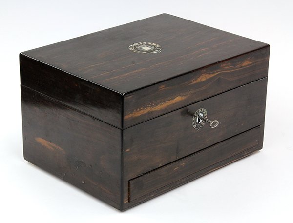 English dressing box: English dressing box. 19th century, the hinged top opening to a fitted and tiered interior retaining the original concealed looking glass backed with gathered velvet fabric, surmounting the spring loa