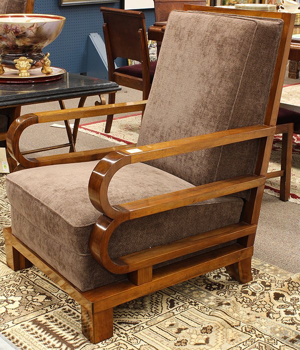 Pair of Art Moderne club chairs: Pair of Art Moderne club chairs, executed in mahogany circa 1940, having stylized double loop returns continuing to the high back upholstered in mocha chenille and rising on a platform base terminatin