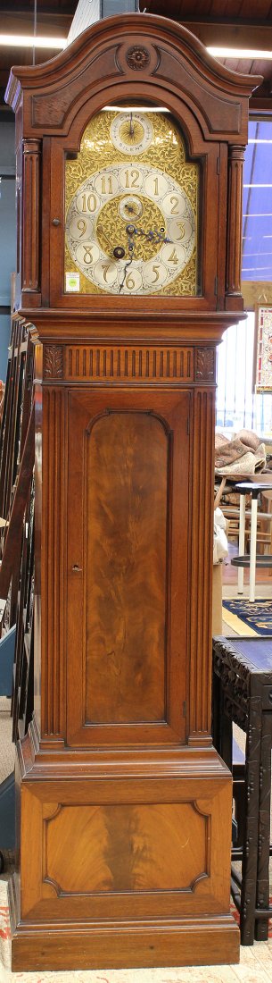 Tiffany and Company grandfather clock: Tiffany and Company five tube tall case clock, the mahogany case with a dome top accented with raised burl panels surmounting the tombstone door, opening to the scroll decorated dial with second hand
