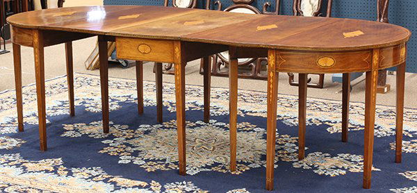 Federal inlaid dining table: Federal inlaid dining table, circa 1800, in three parts, consisting of a central drop leaf with two demi lune ends, the top with five shell form medallions centering each single board accented with di
