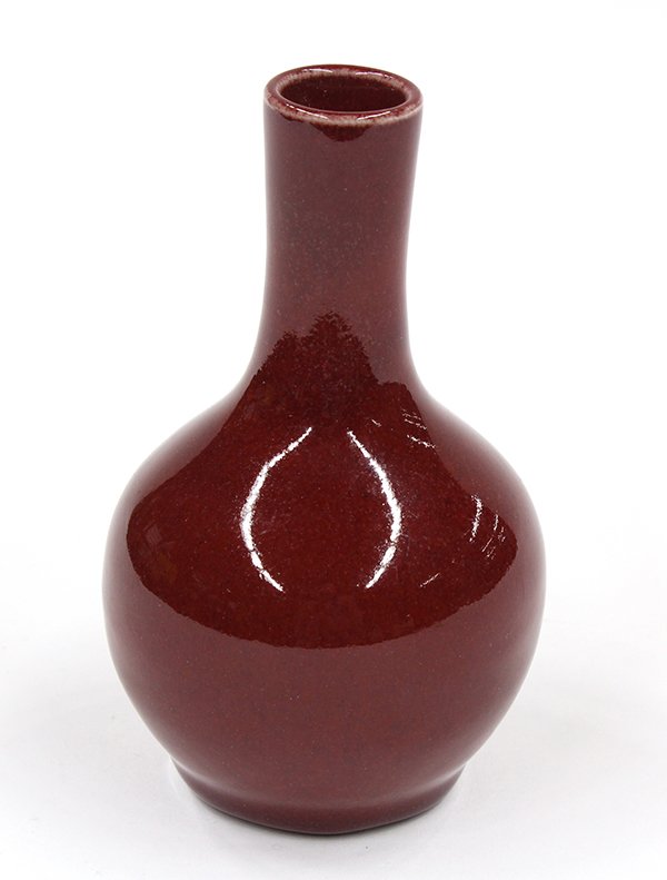 Chinese Ox Blood Stick Neck Vase: Chinese ox-blood glazed stickneck vase, with a mottling on the cylindrical neck and globular body and pooling above the foot, the recessed base coated with a gray crackle glaze , 5.75"h