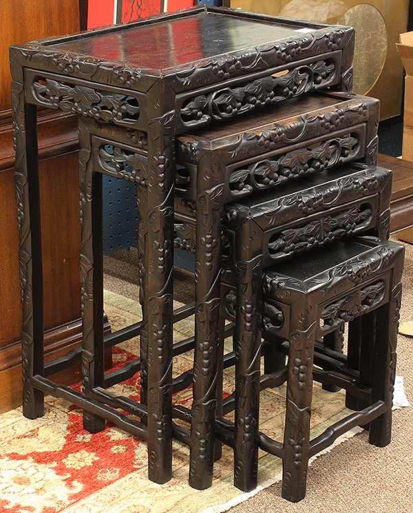 Set of Chinese Nesting Tables, Grapes: (lot of 4) Chinese stained hardwood nesting tables, each featuring vines with clusters of grapes carved to the edges and straight supports, while the pierced apron similarly decorated, largest: 28.5"h