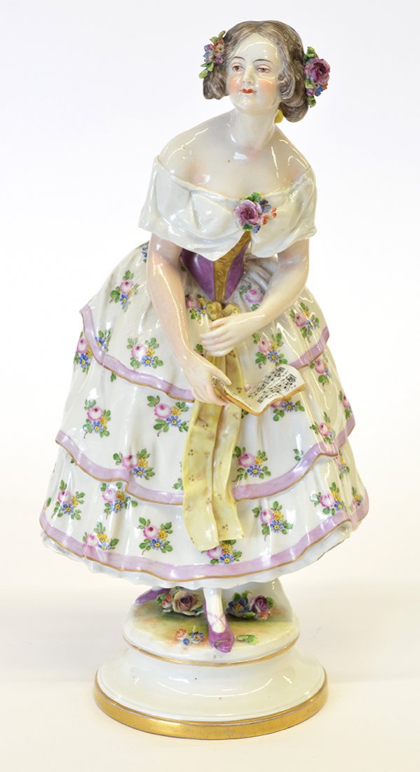 Continental porcelain sculpture of a young beauty: Continental polychromed and gilt accented porcelain figure of a Victorian young beauty with flowers in her hair standing in a naturalistic setting holding a music book, on a socle base, Capodimonte cr