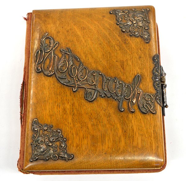 Victorian photo album: Victorian photo album, the oak front cover accented with copper fretwork and 'Photographs', the album contains thirty-five portraits of men, women, children, and babies