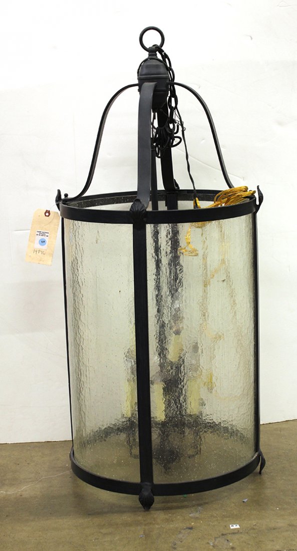 Spanish Revival style chandelier: Spanish Revival style chandelier, the eight light graduated fixture suspended from a tubular wrought support and flanked with four shaped and rolled glass panels set within a wrought frame, 44.5"h x 2