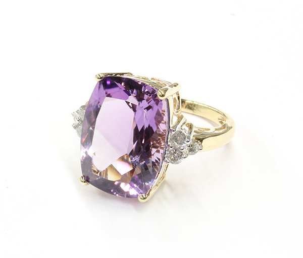 Lady's amethyst and diamond ring; mounted in 14K y: Lady's amethyst and diamond ring; mounted in 14K yellow gold and featuring (1) cushion shape cut amethyst, 13.74 ct., mounted between (6) full cut round diamonds, total weight 0.40 ct. Ring weighs 7.1