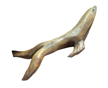 A large Northwest Coast hand carved naturalistic sculpture of a seal