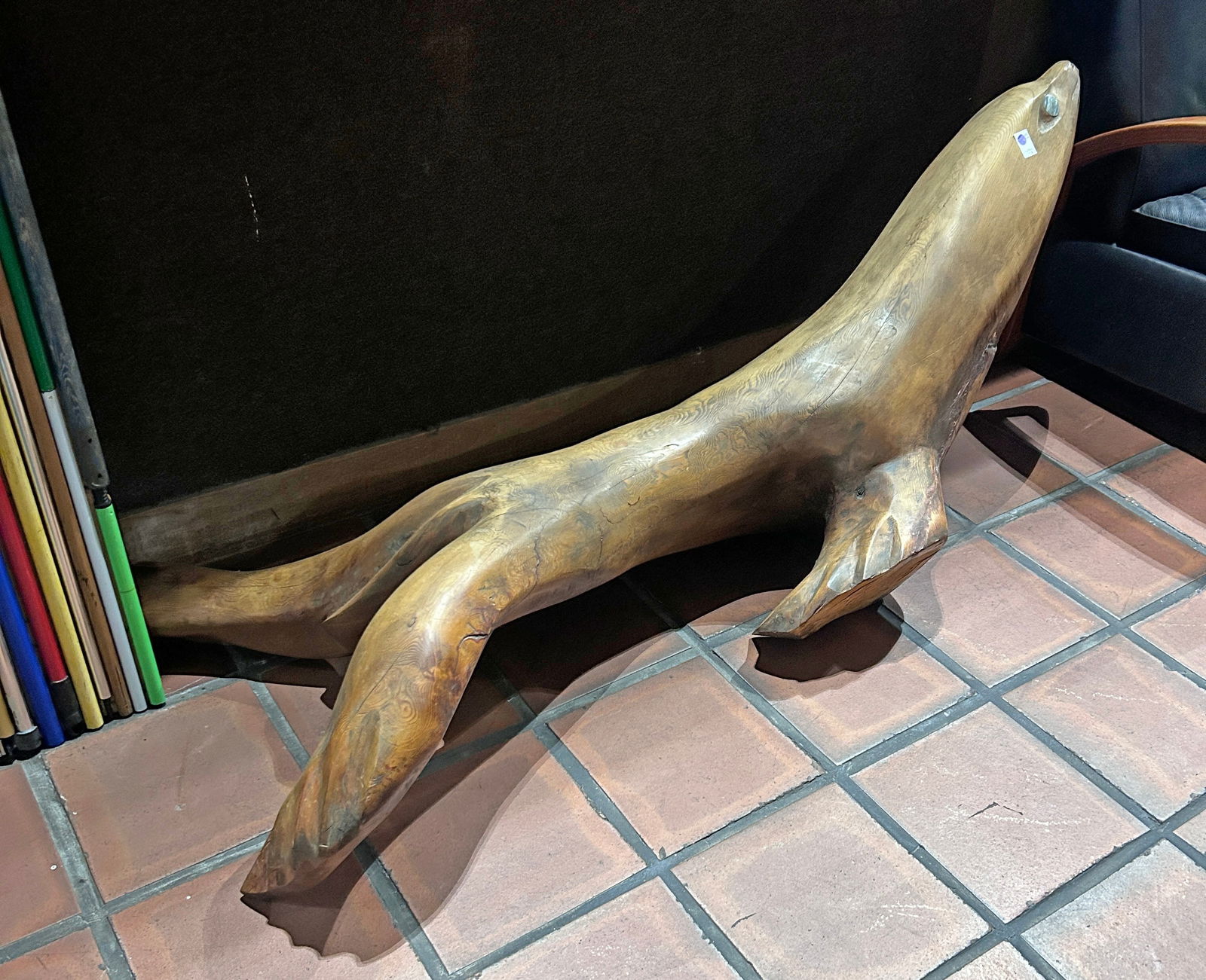 A large Northwest Coast hand carved naturalistic sculpture of a seal (1 of 3)