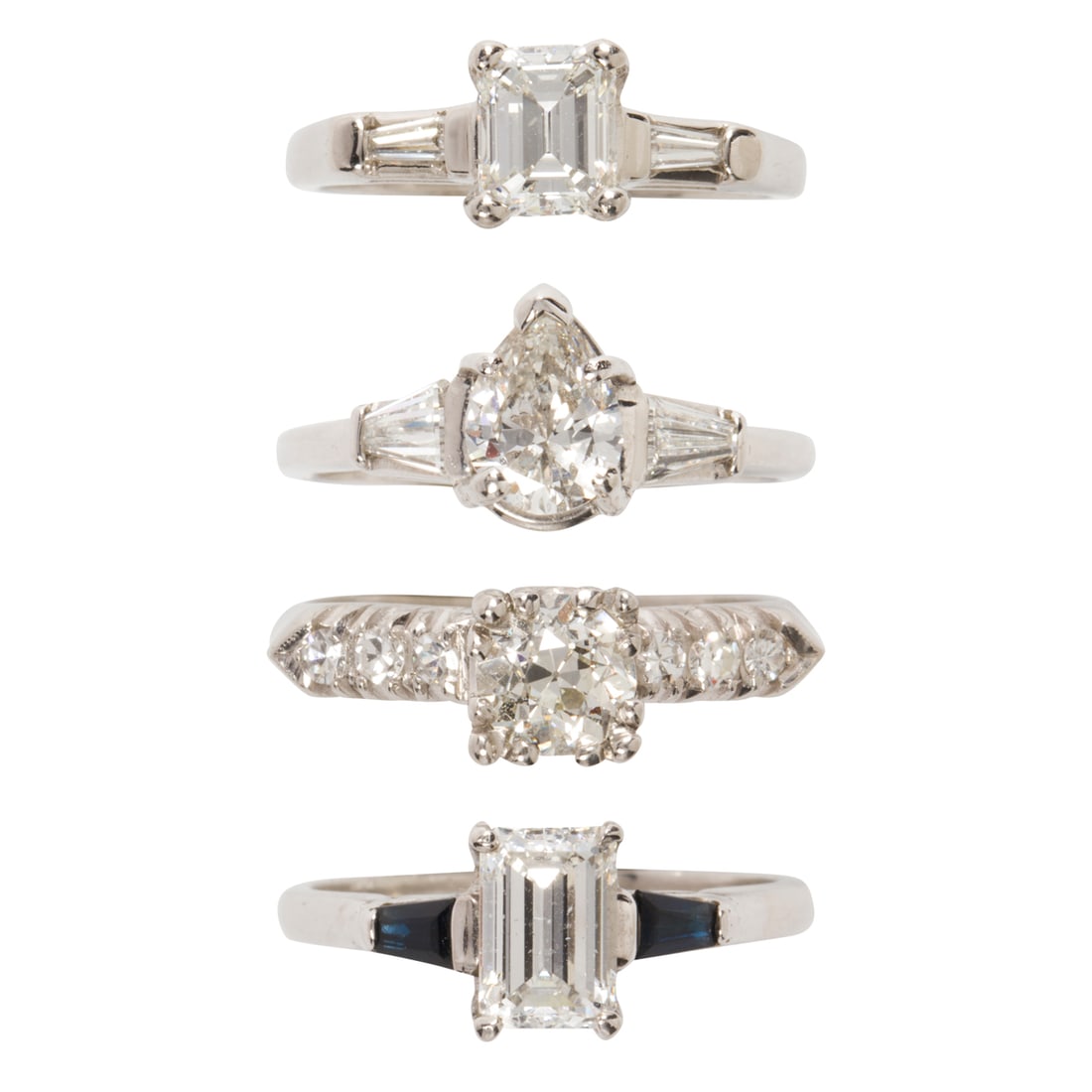 A group of diamond and platinum engagement rings: A group of diamond and platinum engagement rings featuring four engagement rings featuring baguette, pear, and mine-cut diamonds; estimated total diamond weight throughout 3.40 carats;16.9 gross grams