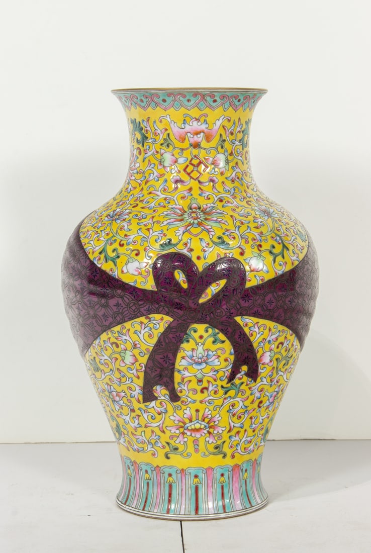 A Chinese famille rose vase: A Chinese famille rose vase. Featuring floral design and bat motif, Qianlong six-character mark, 20th century, 10.5"high.