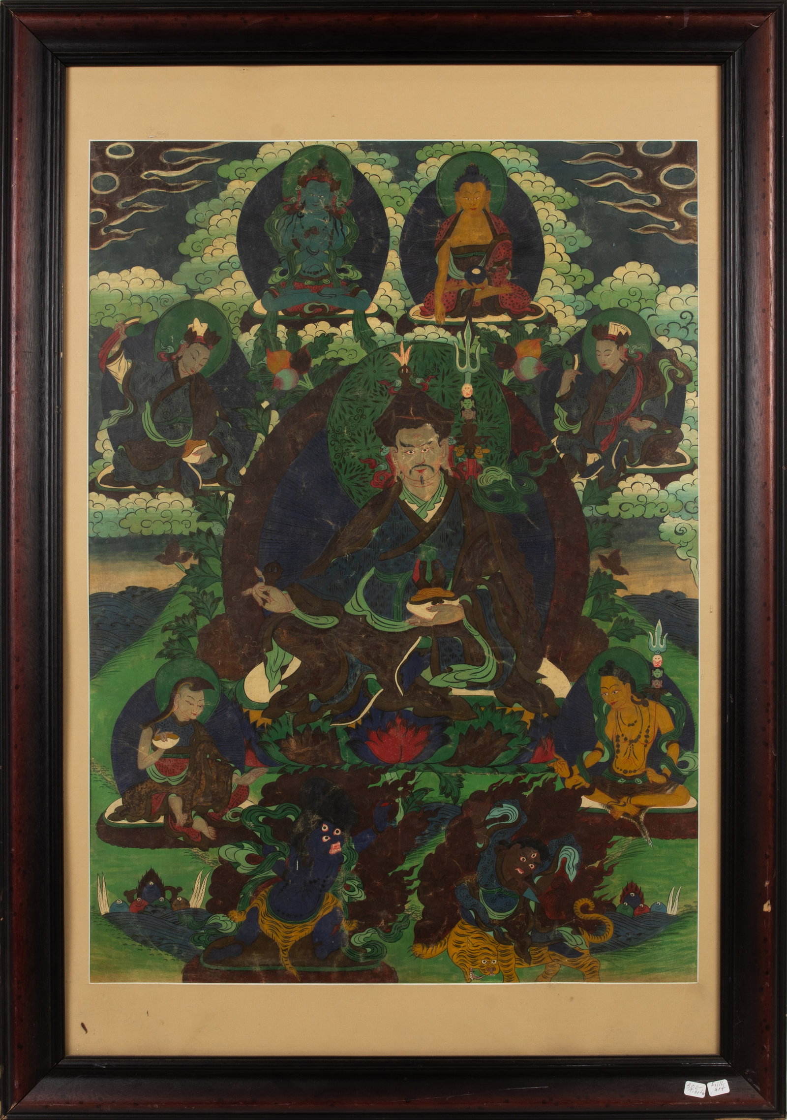 A Tibetan thangka depicting Padmasambhava: A Tibetan thangka depicting Padmasambhava. Distemper on cloth, framed and glazed, 30"h x 22"w.