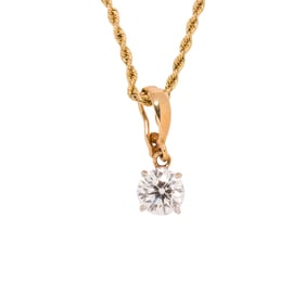 A diamond and 14k gold pendant necklace