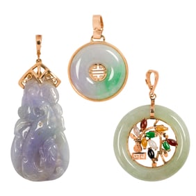 A group of jade and 14k gold pendants