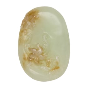 A Chinese white and russet jade oval pendant