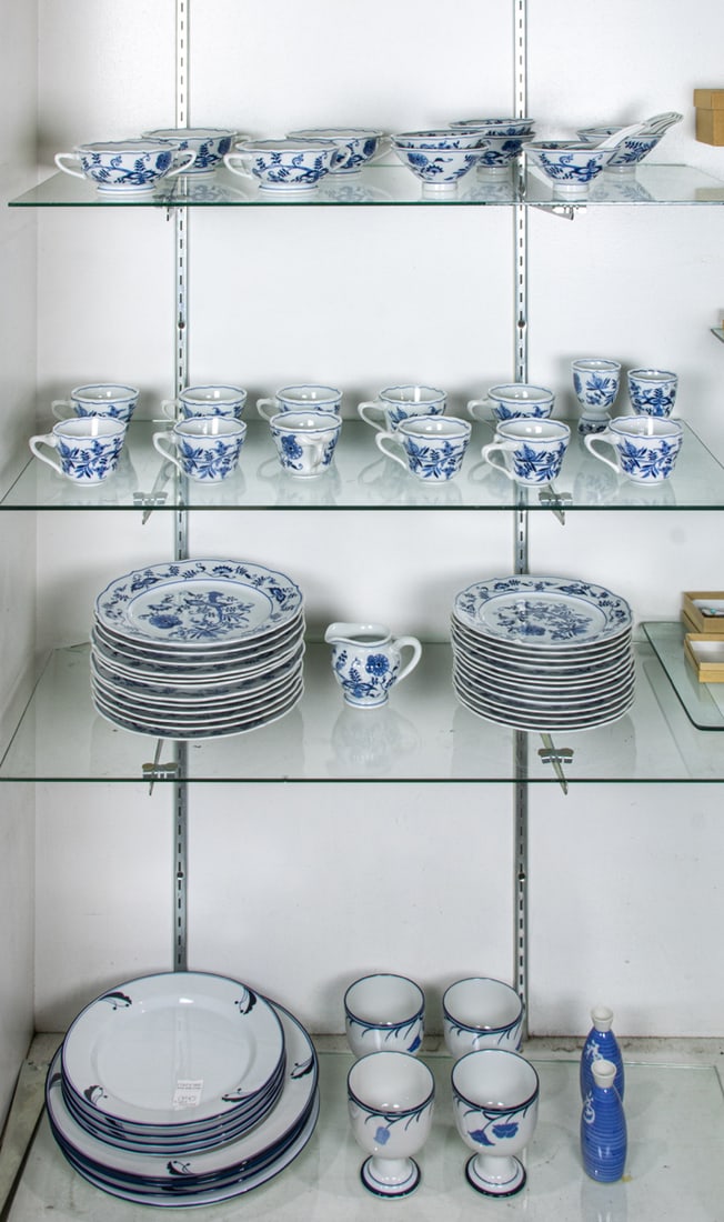A Blue Danube porcelain dinner service in a Blue Onion pattern: A Blue Danube porcelain dinner service in a Blue Onion pattern, comprising (12) dinner plates, 10.25"dia; (13) luncheon plates, 8.75"dia; creamer; (11) cups; (2) egg cups; (4) two-handled cream soups;