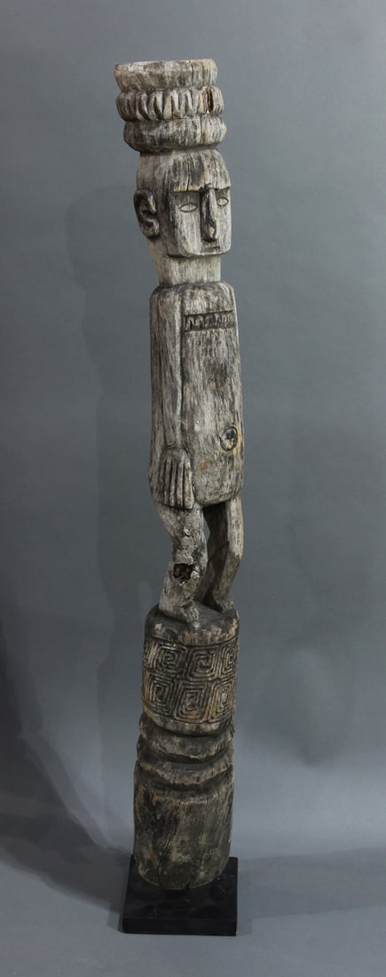 A Tiki totem figure raised on stand, 43"h (overall): A Tiki totem figure raised on stand, 43"h (overall)