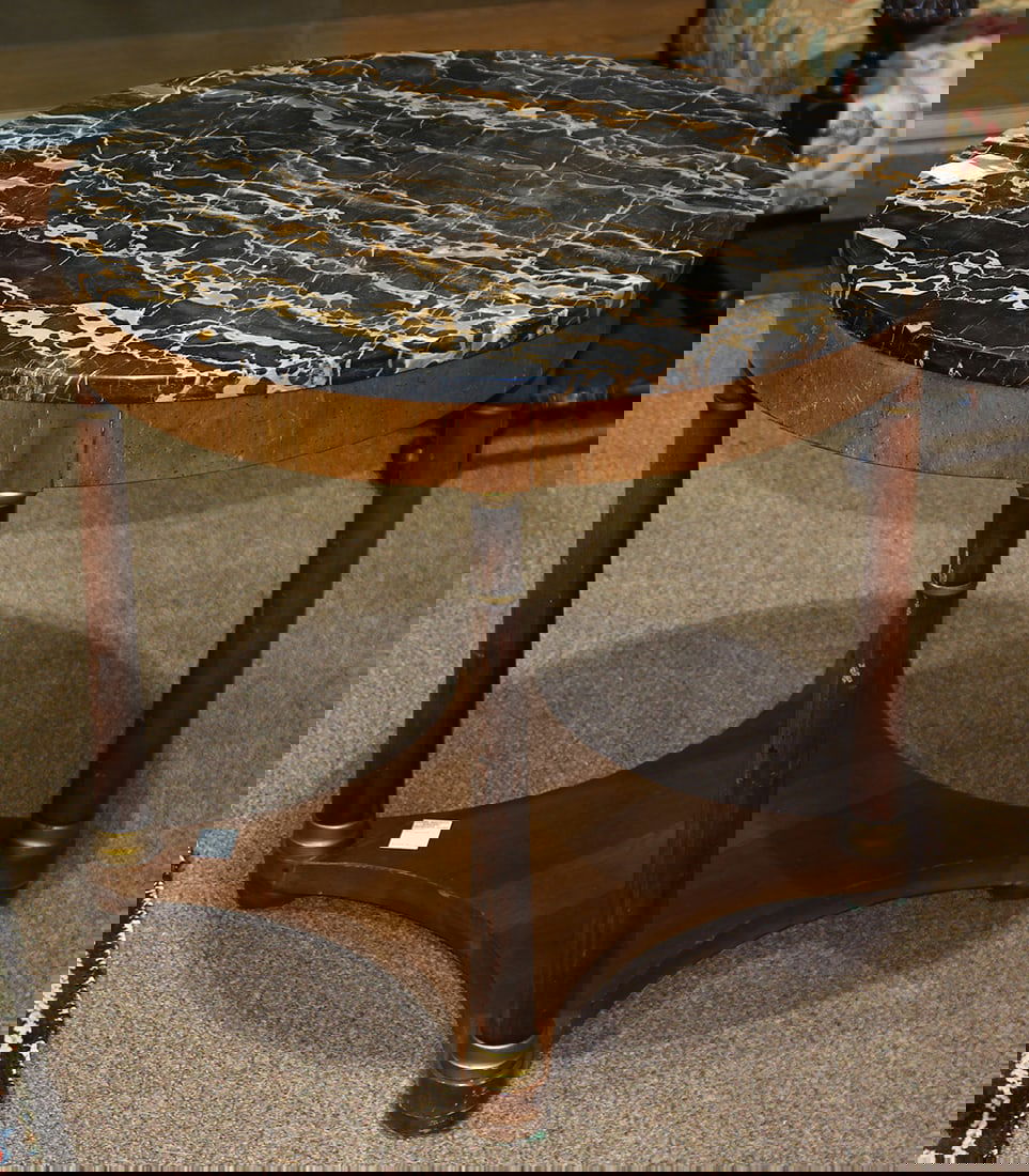 An Empire style gueridon, the variegated marble top above the turned supports terminating at a lower (1 of 1)