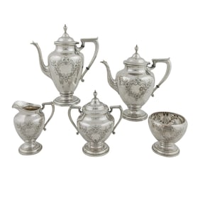 A Wallace floral repousse sterling coffee and tea set in the Lynndale pattern.