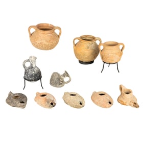 A group of ten Roman terracotta items including oil lamps and jarlets
