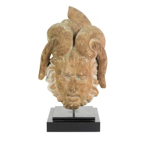 A Roman terracotta head of a satyr