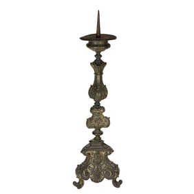 A Continental Baroque metal repousse altar candlestick, 18th century