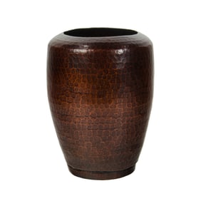 An Arts & Crafts hammered copper vase, circa 1920