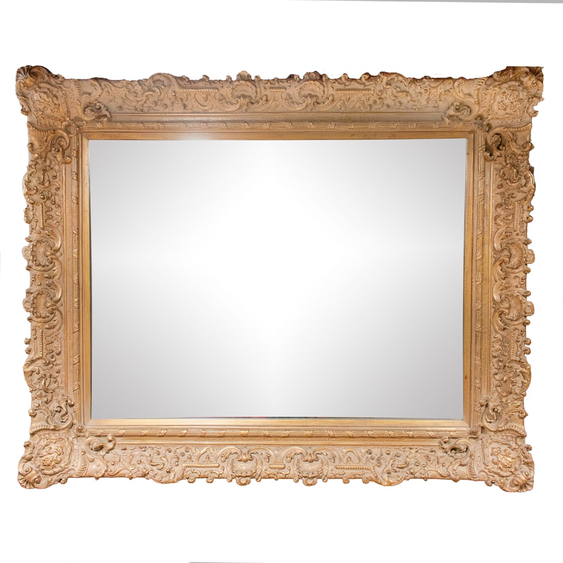 A large Louis XV style giltwood mirror: A large Louis XV style giltwood mirror, the beveled looking glass within a scrolled frame incorporating fleur de lys, shells and foliage, 51"h x 62"w