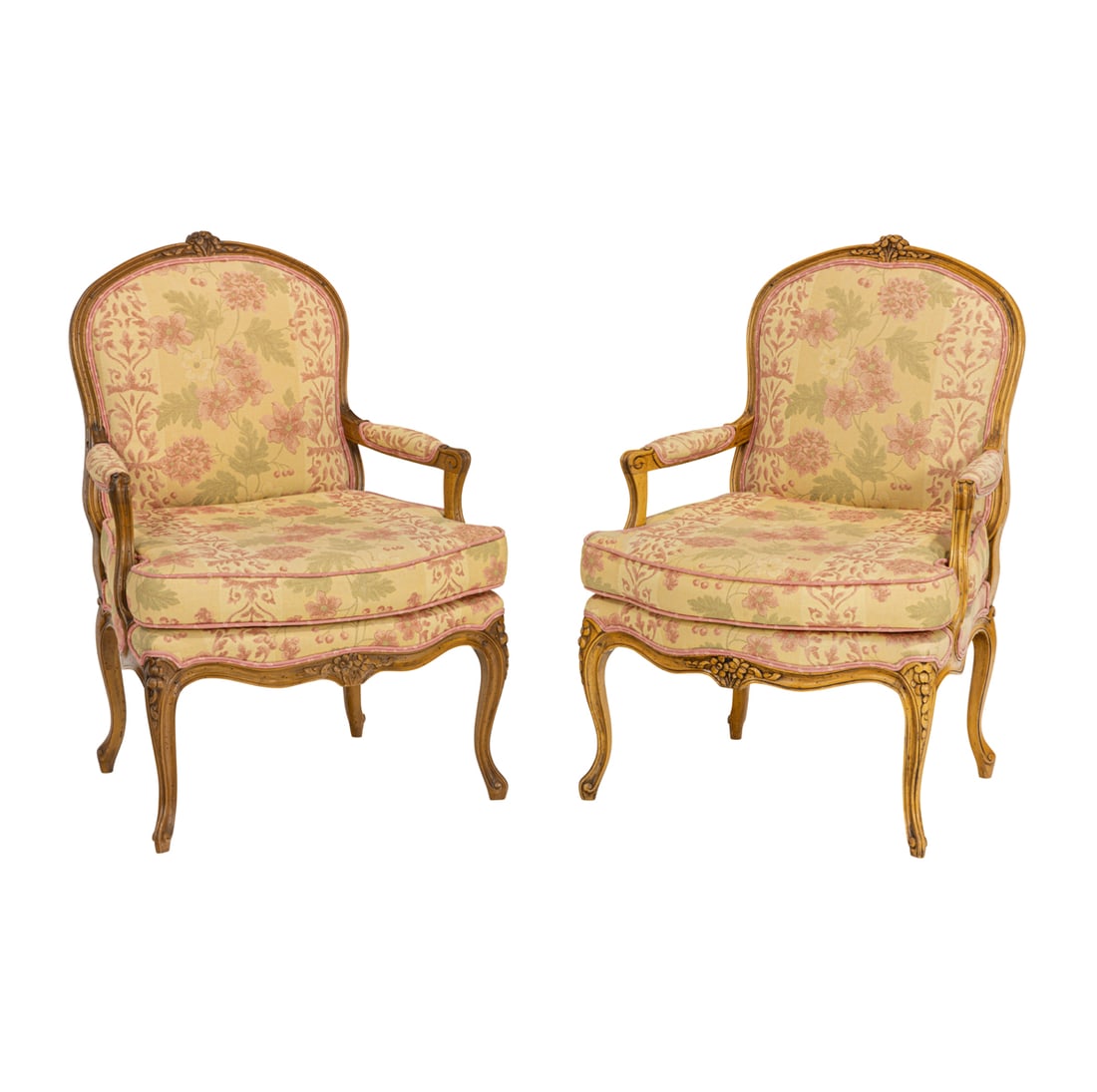 A pair of Louis XV style fauteuil armchairs: A Pair Louis XV style fauteuils armchairs, each padded cartouche shaped back headed with carved floral spray, over a cushion seat, upholstered in a striped Pierre Deux fabric with pink flowers, twin a