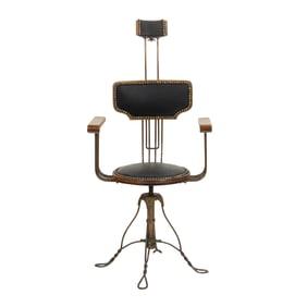 An Arts & Crafts iron and wood adjustable dentist chair