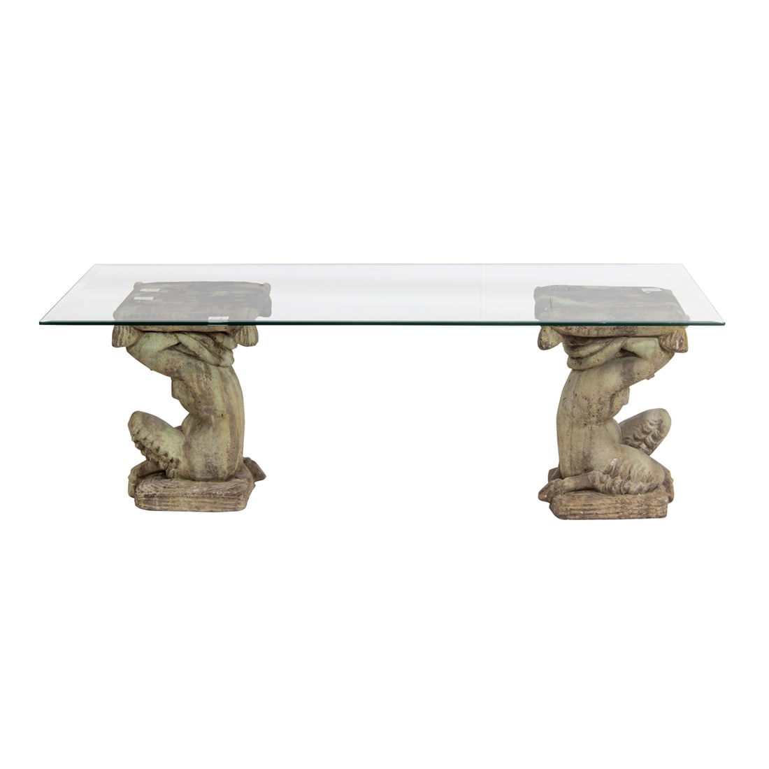 A cast stone and glass coffee table: A cast stone and glass coffee table, the beveled glass top supported on the raised arms of kneeling infant satyrs, 20.25"h x 59.75"w x 29.75"l