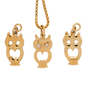 A group of 14k gold pendants and chain