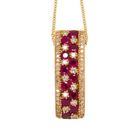 A ruby, diamond and 14k gold pendant with chain