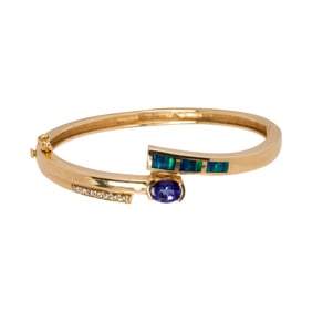 A gem-set and 14k gold bangle bracelet
