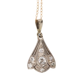 A diamond and platinum pendant with 14k gold chain