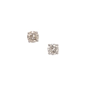 A pair of diamond and 18k white gold solitaire earrings