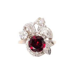 A garnet, diamond, platinum and 14k gold ring