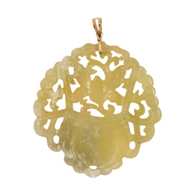 A jade and 14k gold pendant