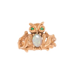 An opal and 14k gold owl ring