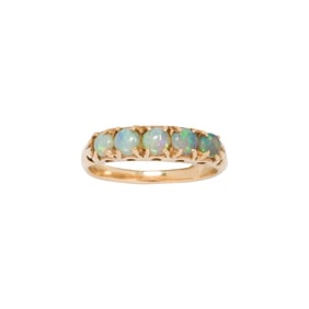 An opal and 14k gold band ring